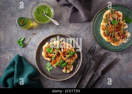 cauliflower steaks with herb sauce and spice. plant based meat substitute Stock Photo