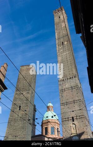 The two famous towers of Bologna, Garisenda and Asinelli at the intersection of the roads to the five gates of the old ring wall Stock Photo
