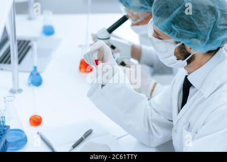 group of scientists conducts research in the laboratory. Stock Photo