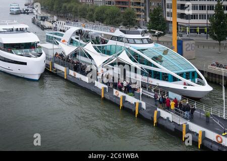 Tourists board and disembark from Spido tourboats on the waterfront in Rotterdam, The Netherlands Stock Photo