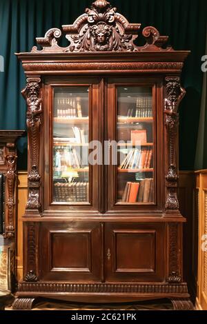 Old antique vintage wooden bookcase with books. Stock Photo