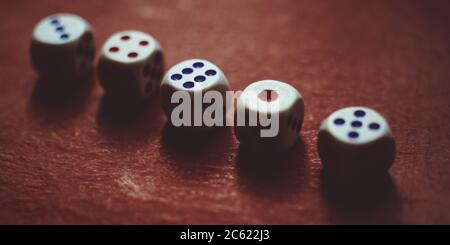 Set of gaming dice on dark red table. Stock Photo