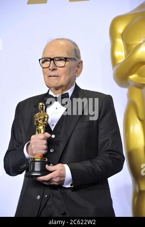 ***FILE PHOTO*** Oscar-Winning Film Composer, Ennio Morricone, Has Passed Away at 91. HOLLYWOOD, CA - FEBRUARY 28: Ennio Morricone in the pressroom at The 88th Annual Academy Awards at the Dolby Theatre in Hollywood, California on February 28th, 2016. Credit: mpi99/MediaPunch Stock Photo