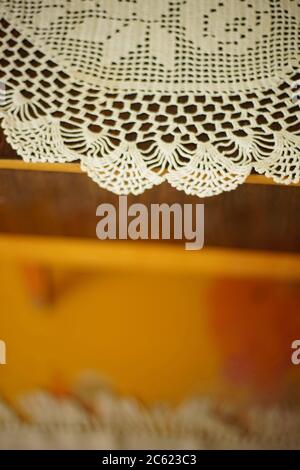 crocheted white napkin on the wooden table Stock Photo