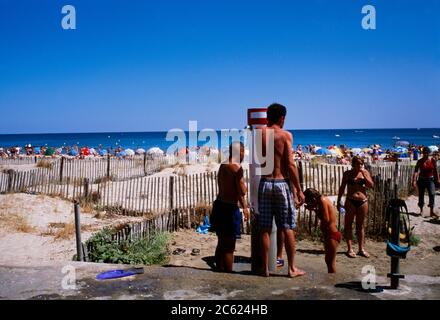 Languedoc Roussillon France Marseillane People using the Showers at the Beach Stock Photo