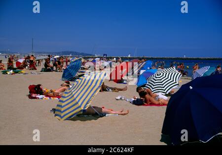Languedoc Roussillon France Marseillane People On The Beach Sunbathing Stock Photo