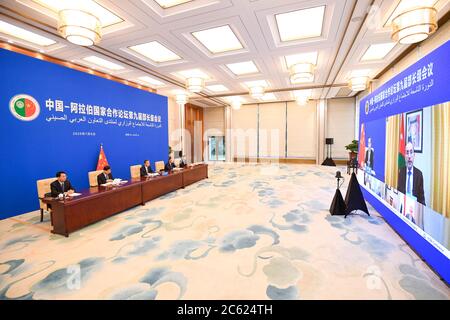 Beijing, China. 6th July, 2020. Chinese State Councilor and Foreign Minister Wang Yi and Jordanian Foreign Minister Ayman Safadi co-chair the 9th ministerial meeting of the China-Arab States Cooperation Forum via video link, July 6, 2020. Credit: Shen Hong/Xinhua/Alamy Live News