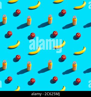 Bright yellow bananas, red apples and bottle of juice on a blue background. Seamless pattern. Stock Photo