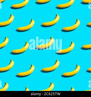 Bright yellow bananas on a blue background. Seamless pattern. Stock Photo