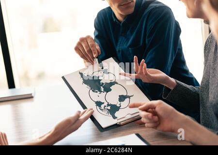 close up. young colleagues discussing new logistics schemes. Elements of this image furnished by NASA Stock Photo