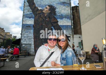 Glasgow, Scotland, UK. 6th July, 2020. Pictured: People out enjoying a drink outside in the beer garden at Hootananny's bar in Glasgow. From today Pubs, bars, cafes and restaurants in England, Scotland and Northern Ireland are welcoming customers for the first time since lockdown began in March. Credit: Colin Fisher/Alamy Live News Stock Photo
