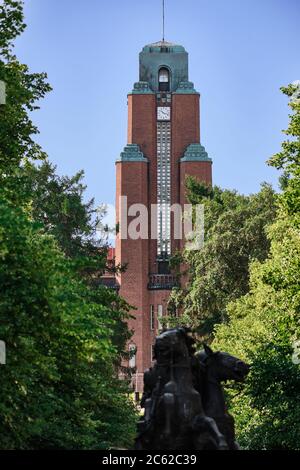 Lahti, Finland - August 6, 2019: View of tower on Town Hall through trees. Clock on the tower. Stock Photo