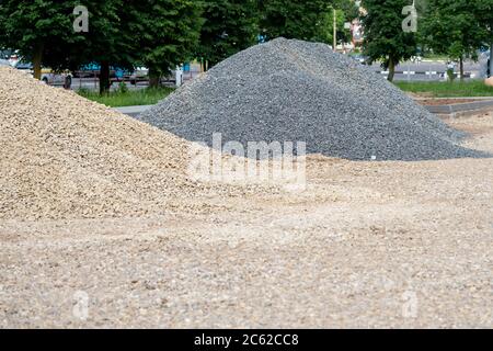 Two heaps of gravel, yellow and gray Stock Photo