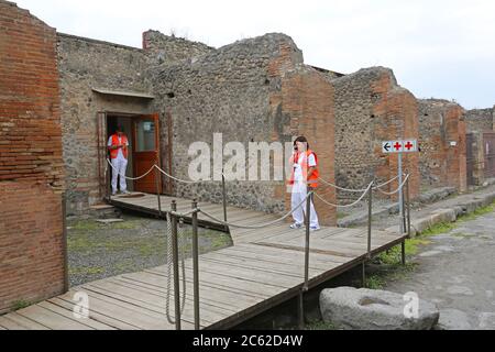 Pompei, Italy - June 25, 2014: Doctors in Front of Ambulance Medical Station at Ancient Ruins in Pompei, Italy. Stock Photo