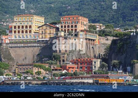 Sorrento, Italy - June 26, 2014: Cliffs and Harbour Port View From Sea Summer Day in Sorrento, Italy. Stock Photo