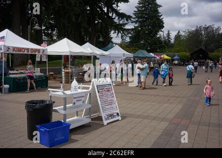 Vendors and shoppers at the Saturday Farmers Market in Lake Oswego, Oregon, on the 4th of July, 2020. Stock Photo