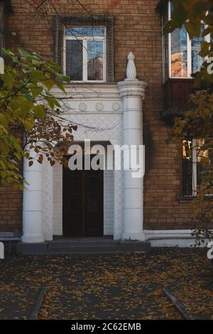 Historic architecture with white columns around the front door of a brick house. Stock Photo