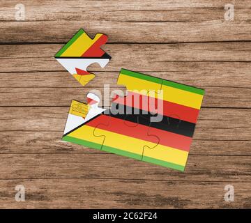 Zimbabwe national flag on jigsaw puzzle. One piece is missing. Danger concept. Stock Photo