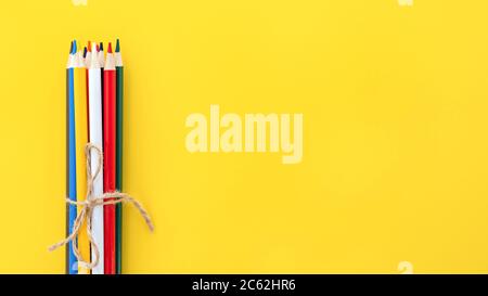 Education and back to school concept. Colourful pencils on the yellow background with space for text. Stock Photo