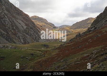 View of the Pen y Pass and its summit (or Llanderis pass) brightly lit on an otherwise overcast afternoon, in Snowdonia mountain range, North Wales Stock Photo