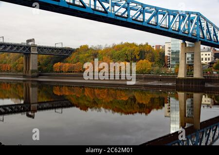 Newcastle Upon Tyne King Edward and Redheugh bridges showing a near perfect reflection in the River Tyne on an autumn morning Stock Photo