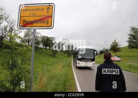 06 July 2020, Bavaria, Obergünzburg: A female member of the criminal investigation department walks towards the public bus standing at the side of the road. In front of other passengers, a man on the bus stabbed his separated wife to death. Photo: Benjamin Liss/dpa Stock Photo