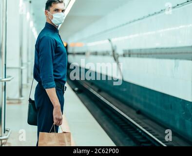passengers in protective masks waiting for the metro train Stock Photo