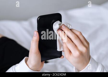 Cleaning the smartphone screen with a fiber cloth. Stock Photo