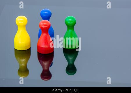 Different leisure game pawn figures, concept for diverse group of people. Cutout, isolated on white. Stock Photo