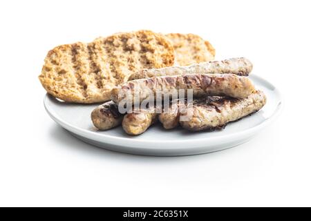Grilled white sausages on plate isolated on white background. Stock Photo