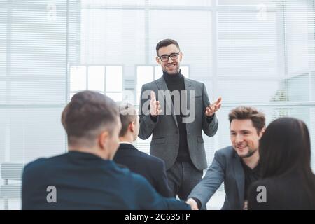 smiling employees shaking hands during a working meeting Stock Photo