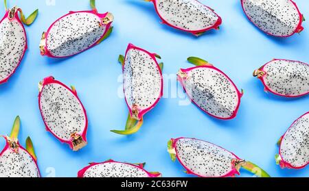 Ripe dragonfruit or pitahaya slices on blue background. Top view Stock Photo
