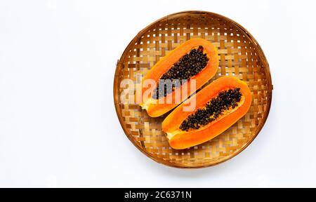 Papaya on wooden bamboo threshing basket on white background. Copy space Stock Photo