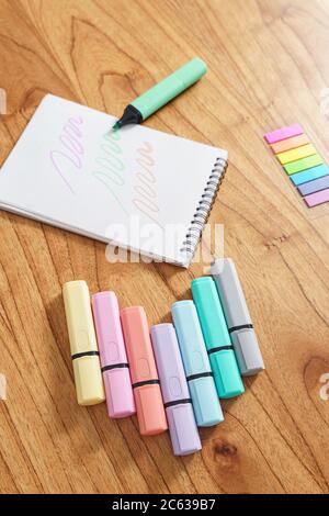 Drawing on a white sheet with a color highlighter. Top View Stock Photo