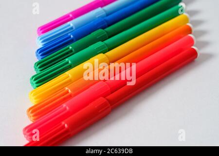 Colored markers on a white sheet. Stock Photo