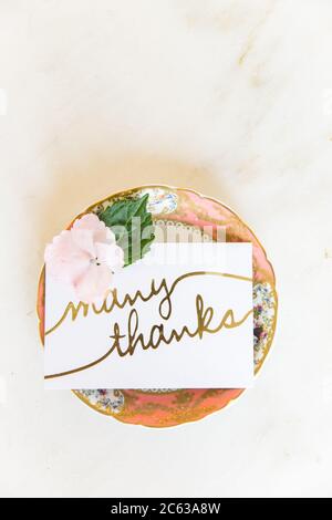 Colorful plate holding a 'many thanks' note / card Stock Photo