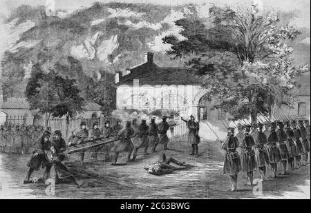 The Harper's Ferry insurrection -The U.S. Marines storming the engine house - Insurgents firing through holes in the doors. 1859 Stock Photo
