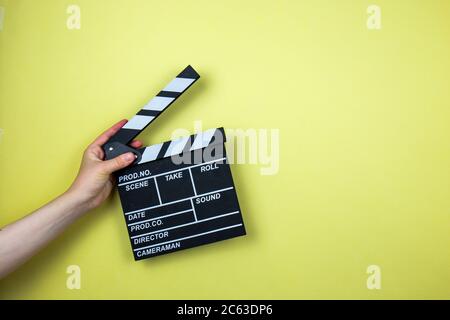 Cinema and movie making background. Clapperboard with 3d glasses and frame  in form of film strip isolated on yellow background minimal creative concep  Stock Photo - Alamy