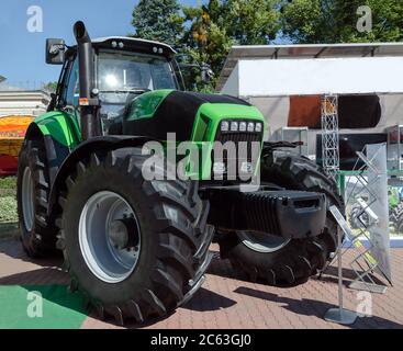 tractor with big wheels, machine for agricultural work and transportation of goods, close-up Stock Photo