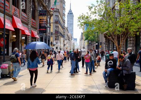 People, shops and restaurants at the always busy Madero boulevard in downtown Mexico City Stock Photo
