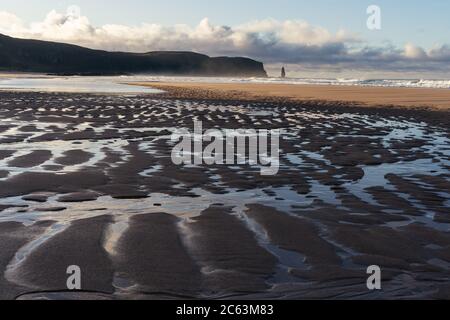 Sandbar at sunset with sea stack and waves crashing Stock Photo