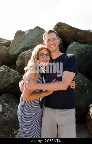 Mother & Son Hugging and Smiling for Camera at Beach Stock Photo
