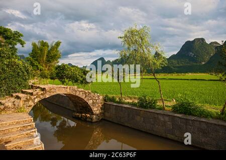 arched pedestrian bridge in rural China close to Yangshuo Stock Photo