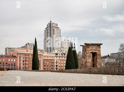 Ground level of majestic cityscape of aged stone arch and contemporary buildings in Madrid Stock Photo