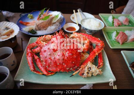 King Crab or whole Taraba crab, grilled and placed on a green plate is an expensive and spectacular Japanese meal. Stock Photo