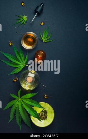 medical-cbd-oil-tincture-on-black-trendy-background-with-cannabis-leaves-2c6426g.jpg