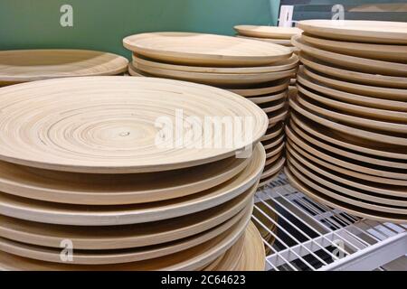 On the shelf are decorative wooden plates in the store Stock Photo