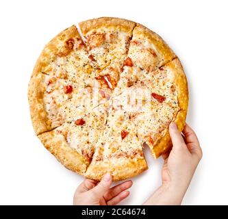 Tasty homemade cheese pizza with tomatoes with hands isolated on white background. Top view of sliced pizza. Stock Photo