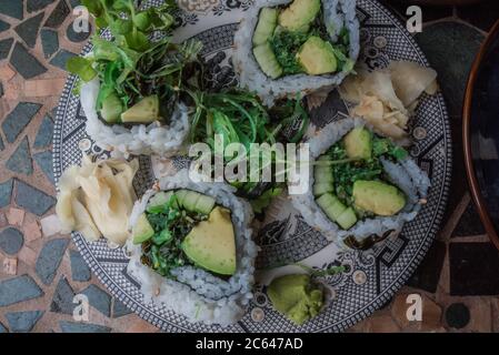 Home made vegan sushi rolls with rice, seaweed, tofu, avocado, and other flavors. Stock Photo