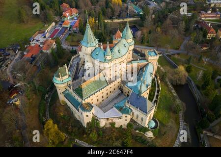 Bojnice castle from bird's eye view encircled by moat, greenery and buildings. Stock Photo